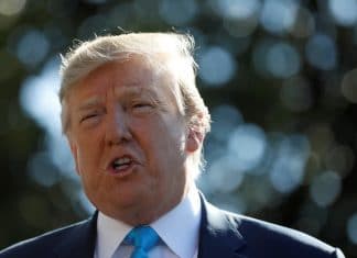 President Donald Trump talks to reporters as he departs for travel to Texas from the White House in Washington