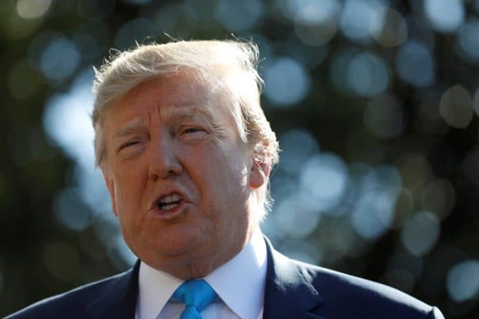 President Donald Trump talks to reporters as he departs for travel to Texas from the White House in Washington