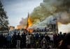 People watch the landmark cathedral burning in central Paris