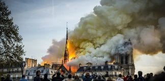 People watch the landmark cathedral burning in central Paris
