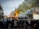 People watch the landmark cathedral burning in central Paris