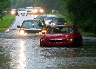 Vehicles wade through flooded Kingwood Drive as deadly thunderstorms hit the Kingwood area Tuesday, May 7, 2019, in Texas.