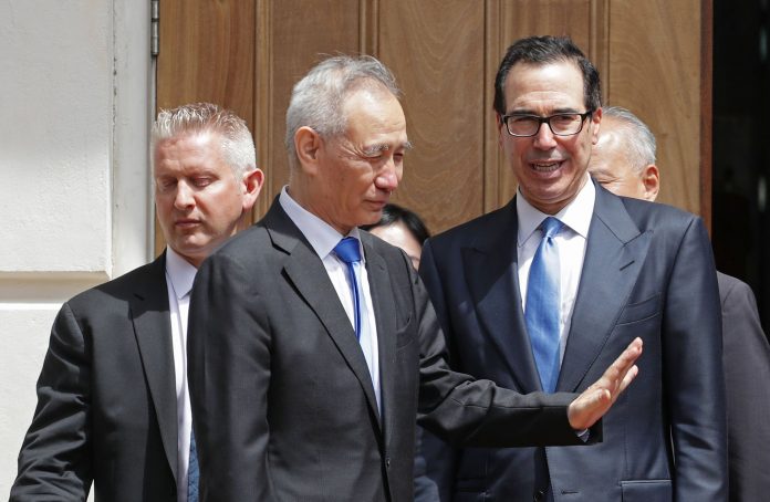 Chinese Vice Premier Liu He (2nd L) says goodbye to U.S. Treasury Secretary Steven Mnuchin as they break from meetings at the USTR offices May 10, 2019