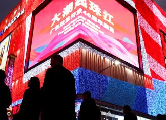 People stroll through a shopping district in the southern city of Shenzhen. Tax cuts will be one of the methods used to support the Chinese economy.