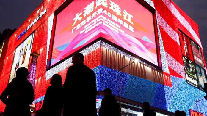 People stroll through a shopping district in the southern city of Shenzhen. Tax cuts will be one of the methods used to support the Chinese economy.