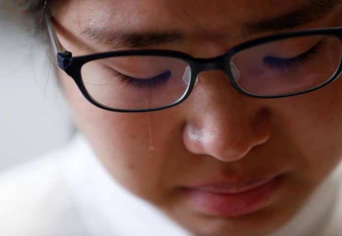 Miwa Moriya cries while she speaks during an interview with Reuters at her house in Yokohama, Japan, April 24, 2019.