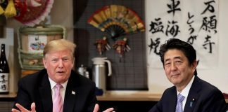 US President Donald Trump with Japanese Prime Minister Shinzo Abe during a dinner at a hibachi