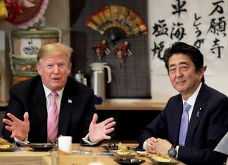 US President Donald Trump with Japanese Prime Minister Shinzo Abe during a dinner at a hibachi