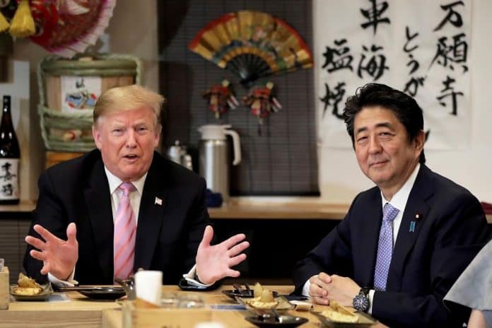 US President Donald Trump with Japanese Prime Minister Shinzo Abe during a dinner at a hibachi