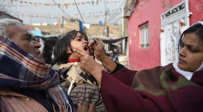 A Pakistani health worker administers polio vaccine drops to a child during a polio vaccination campaign in Islamabad on December 12, 2018.
