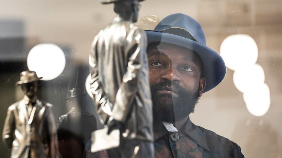 : Artist Samson Kambalu inspects a model of his work 'Antelope' during the Fourth Plinth winner announcement at National Gallery on July 05, 2021 in London