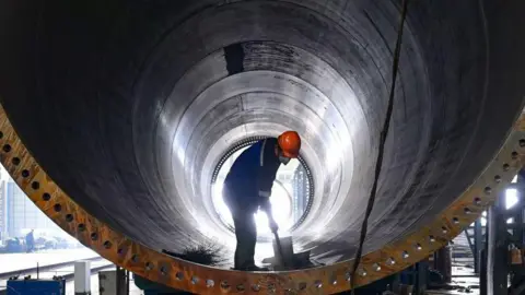 Getty Images A worker works on the production line of a wind power equipment manufacturing enterprise in Baishui County, Weinan, China, on 16 October, 2024.