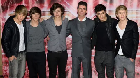 Getty Images One Direction with Simon Cowell in 2010