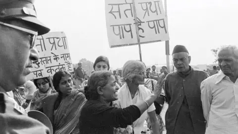 Getty Images A group of progressive women's groups in New Delhi on November 11, 1987, protested against the obsolete tradition of some of the Hindu communities where widows were forced to commit Sati — sitting on the pyre of their husband and burning. (Photo by Sondeep Shankar/Getty Images)