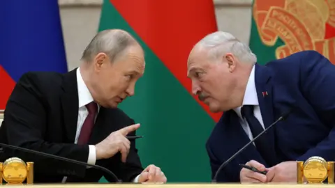 Reuters Presidents Vladimir Putin and Alexander Lukashenko meet at a state council. The Belarussian and Russian flags are behind them.