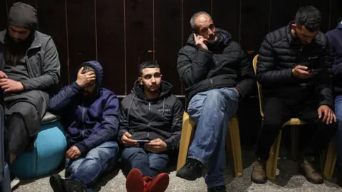 Getty Images Palestinian families react after Israel delayed the release of Palestinian prisoners, scheduled to be released in the seventh hostage-prisoner exchange, in the occupied West Bank city of Ramallah early on February 23, 2025.