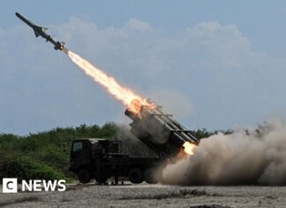 Japan defence minister denies militarism, criticises China's 'huge arsenal'